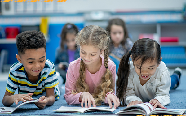 three young students reading books