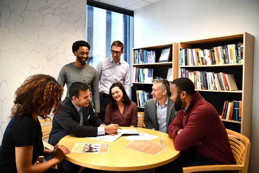 Group of higher education adults working together at a table