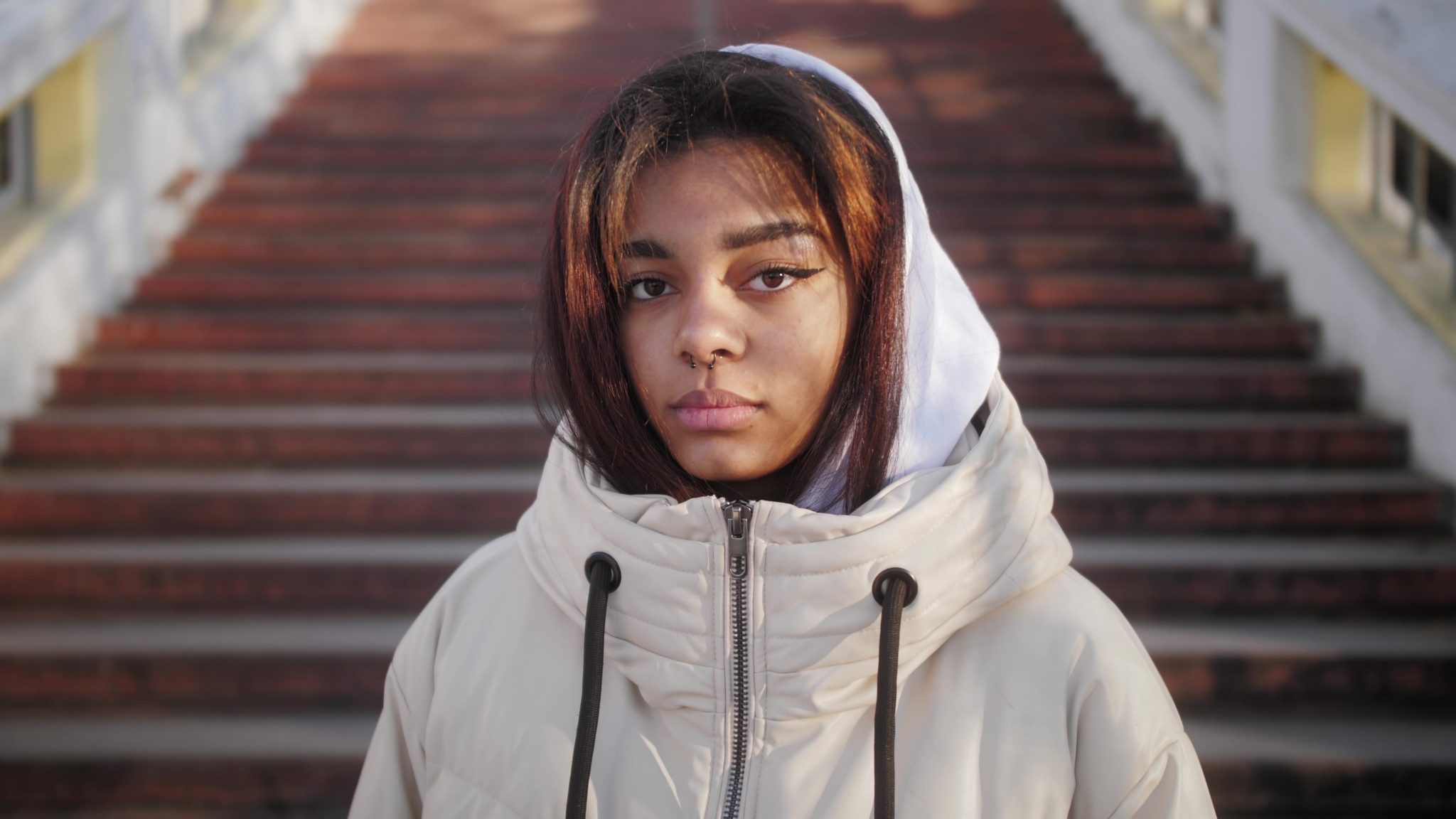 Black girl wearing hoodie, looking sad