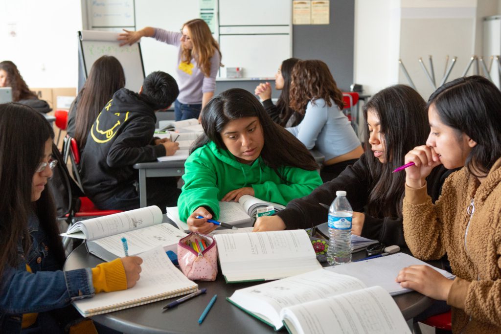 students in a classroom discussing schoolwork