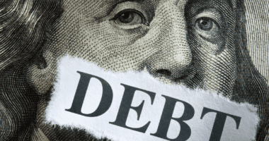 Benjamin Franklin with the word debt over his mouth