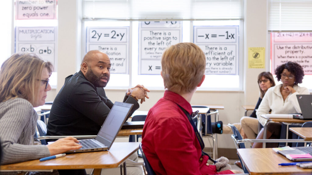 Sixth-grade math teachers discuss their lessons during a team planning session.